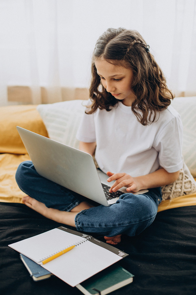 School girl studying at home, distant learning