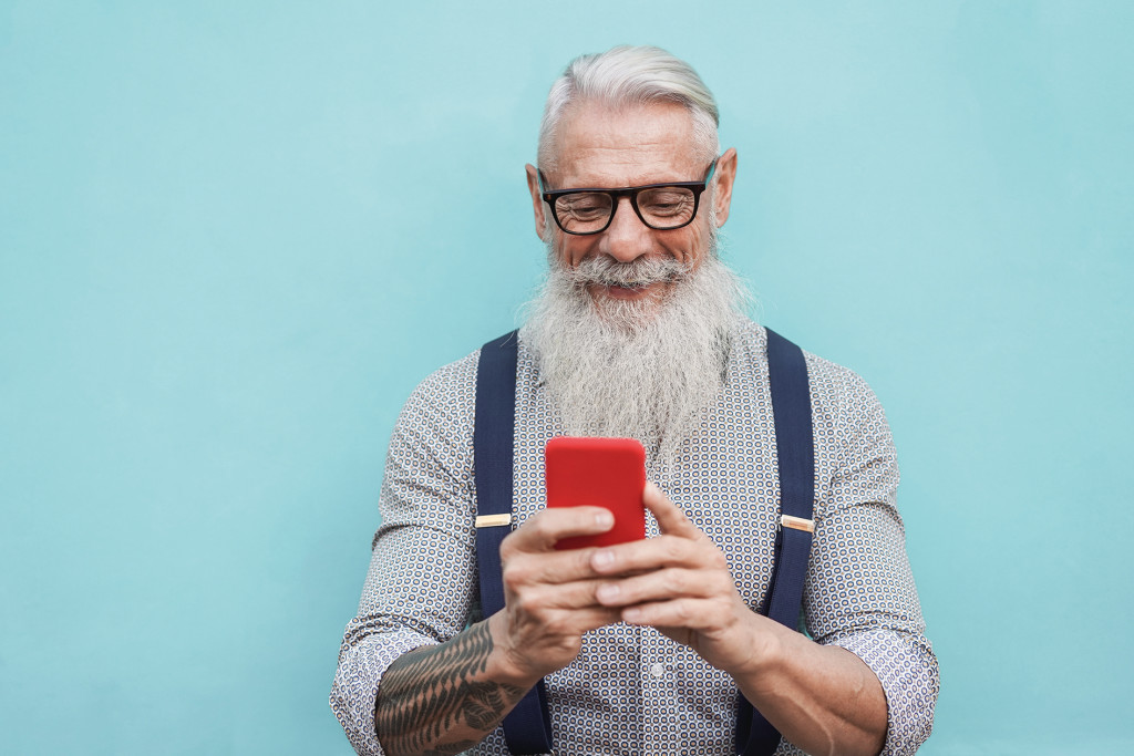 Happy,Senior,Hipster,Man,Using,Mobile,Phone,Outdoors,In,The