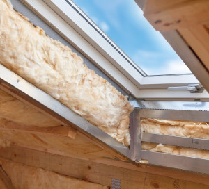Plastic (mansard) or skylight window on attic with environmentally friendly and energy efficient thermal insulation rockwool.