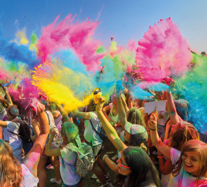 Thessaloniki, Greece - September 2, 2018: Crowds of unidentified people throw colour powder during the "Day of Colours" annual event.