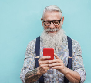 Happy,Senior,Hipster,Man,Using,Mobile,Phone,Outdoors,In,The