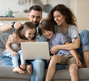 Family,With,Little,Kids,Spend,Time,Together,Seated,On,Couch