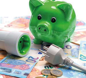 Energy cost, saving energy concept. Piggy bank with socket and plug and money