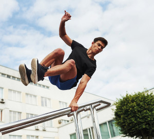 Silver,Colored,Railings.,Young,Sports,Man,Doing,Parkour,In,The