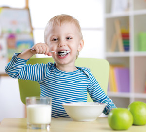 kid eating healthy food at home or kindergarten
