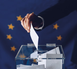 Man throwing his vote into the ballot box. EU elections. Elections to the European Parliament